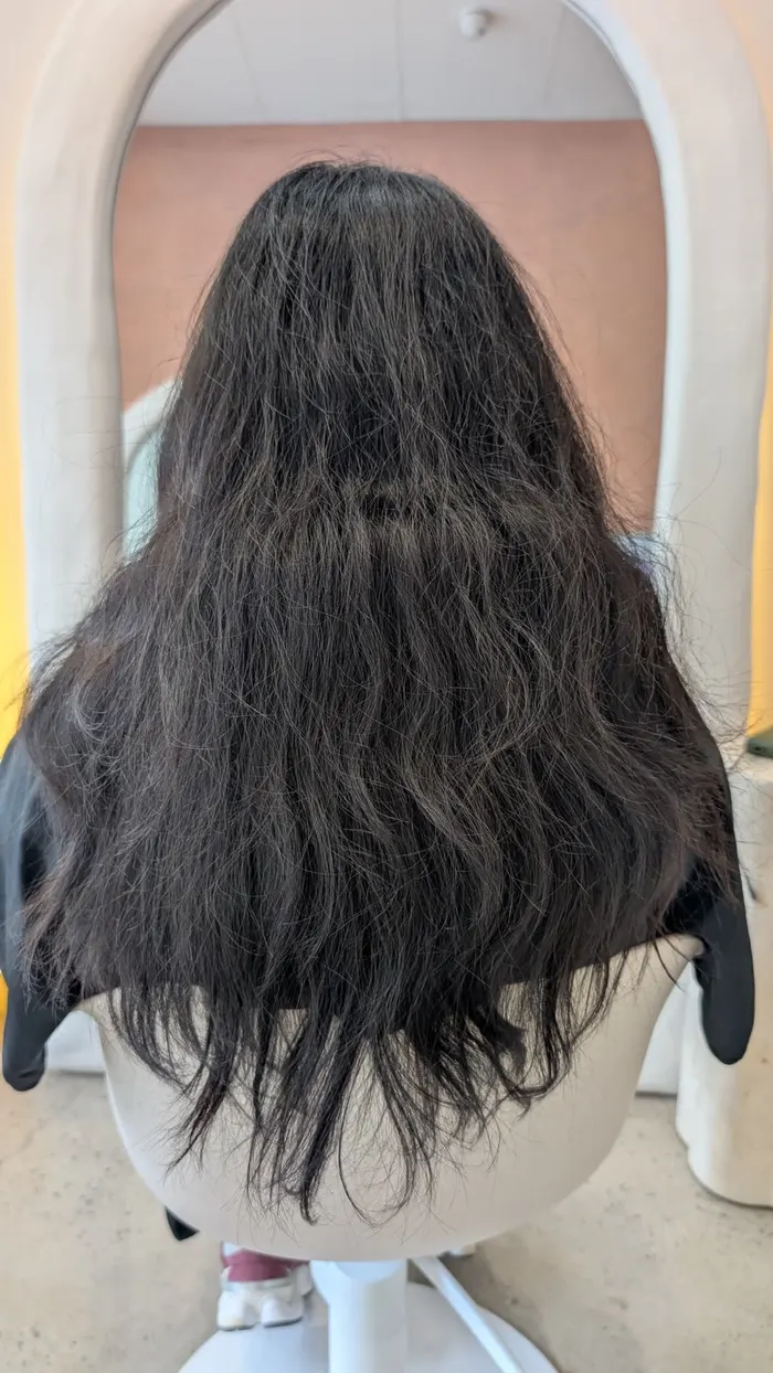 Long black curly hair before nanoplasty treatment