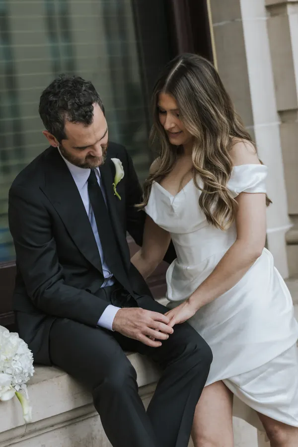 A couple on the steps outside a registry, long waves worn down