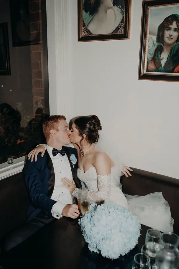 A quiet moment in a bar booth, hair swept into a textured updo