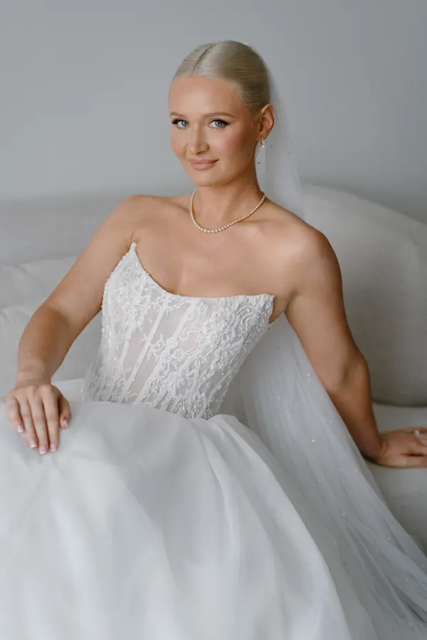 A sleek pulled-back style above a strapless lace gown